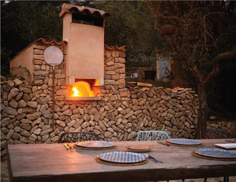 Shaded outdoor dining area at The Lions Villa with countryside views