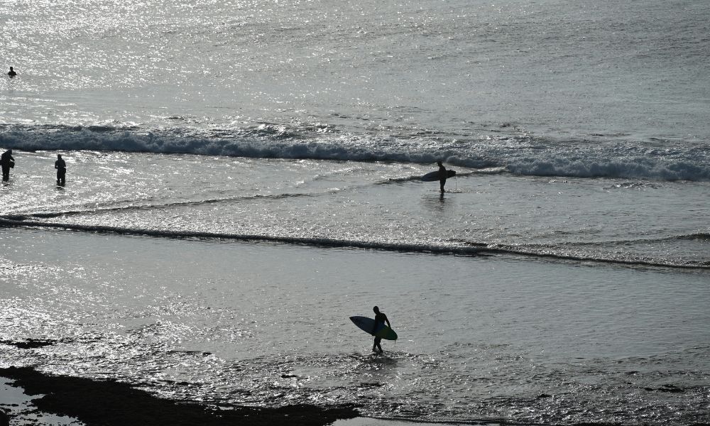 Surfer riding a right-hand wave at Sanur Reef in Bali