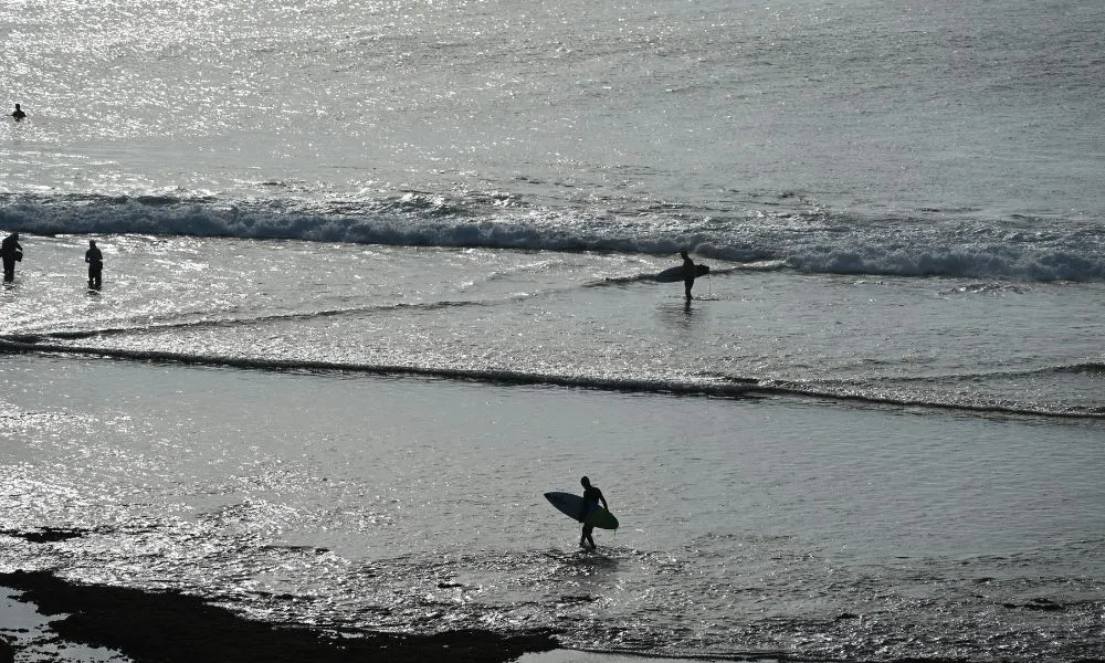 Surfer riding a right-hand wave at Sanur Reef in Bali