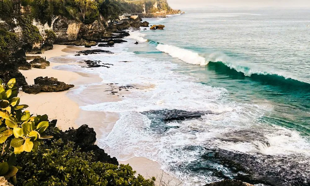 Experienced surfer riding a powerful wave at Tandjung Reef in Sanur