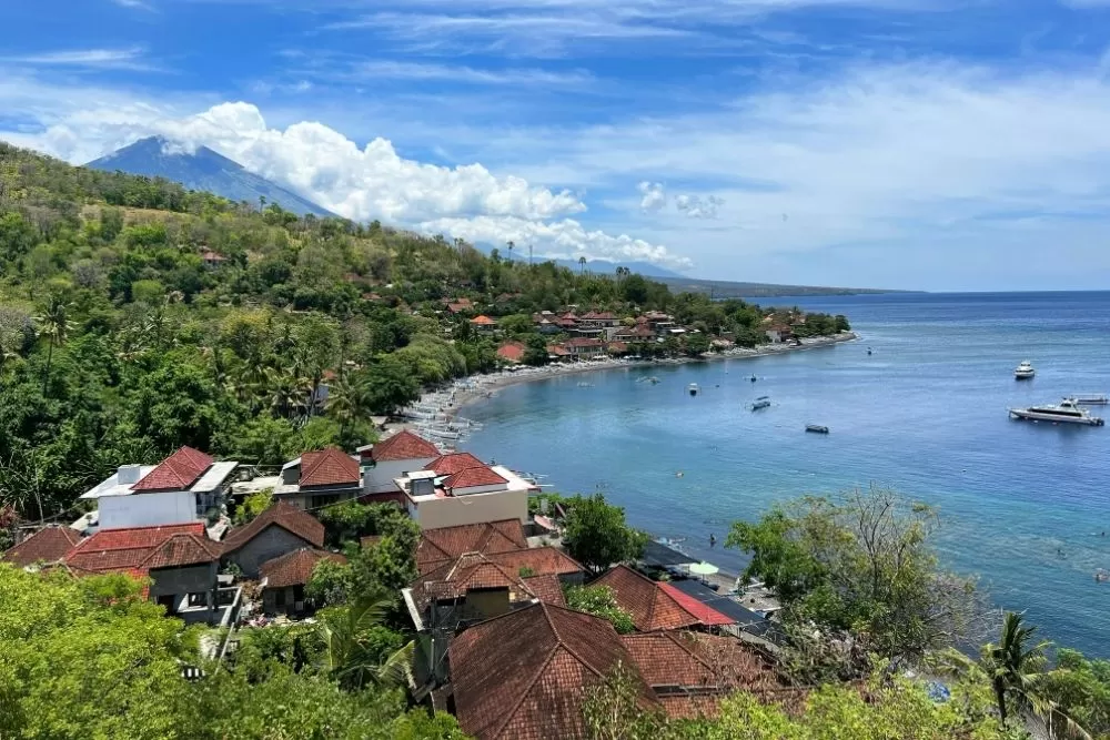 Amed Bali snorkeling coral garden with colorful tropical fish and volcanic sand beach