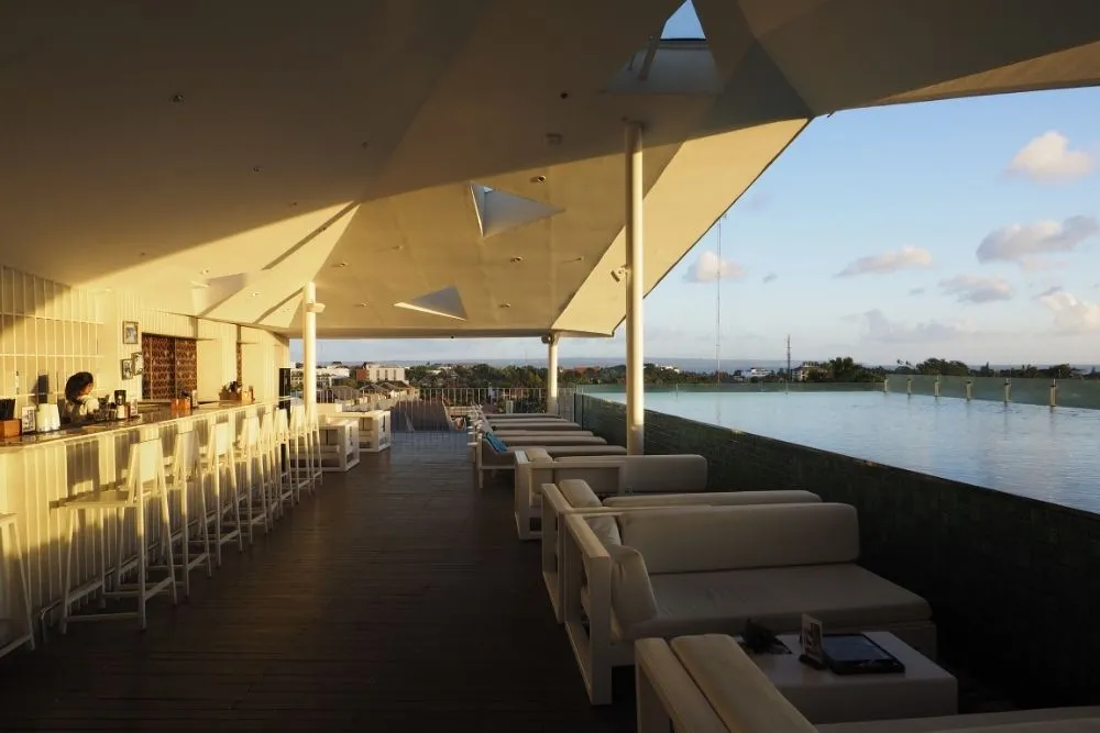 Family relaxing by the rooftop pool at IZE Seminyak hotel in Bali